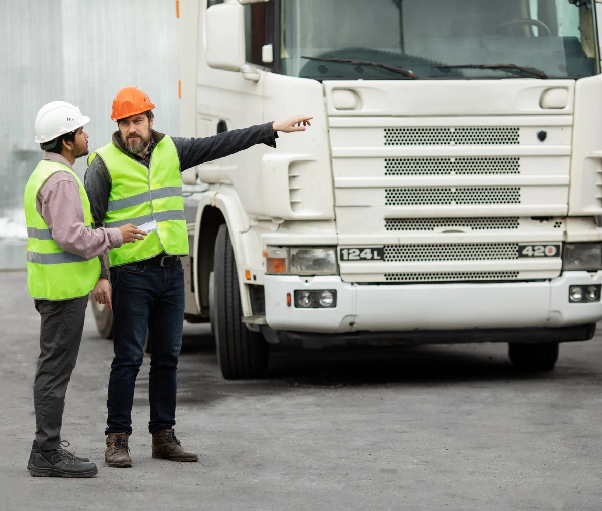 Class 1 driving school trainer guide to new driver in parking lot.